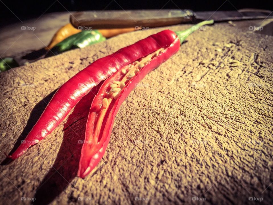 Chili pepper on old wooden cutting board