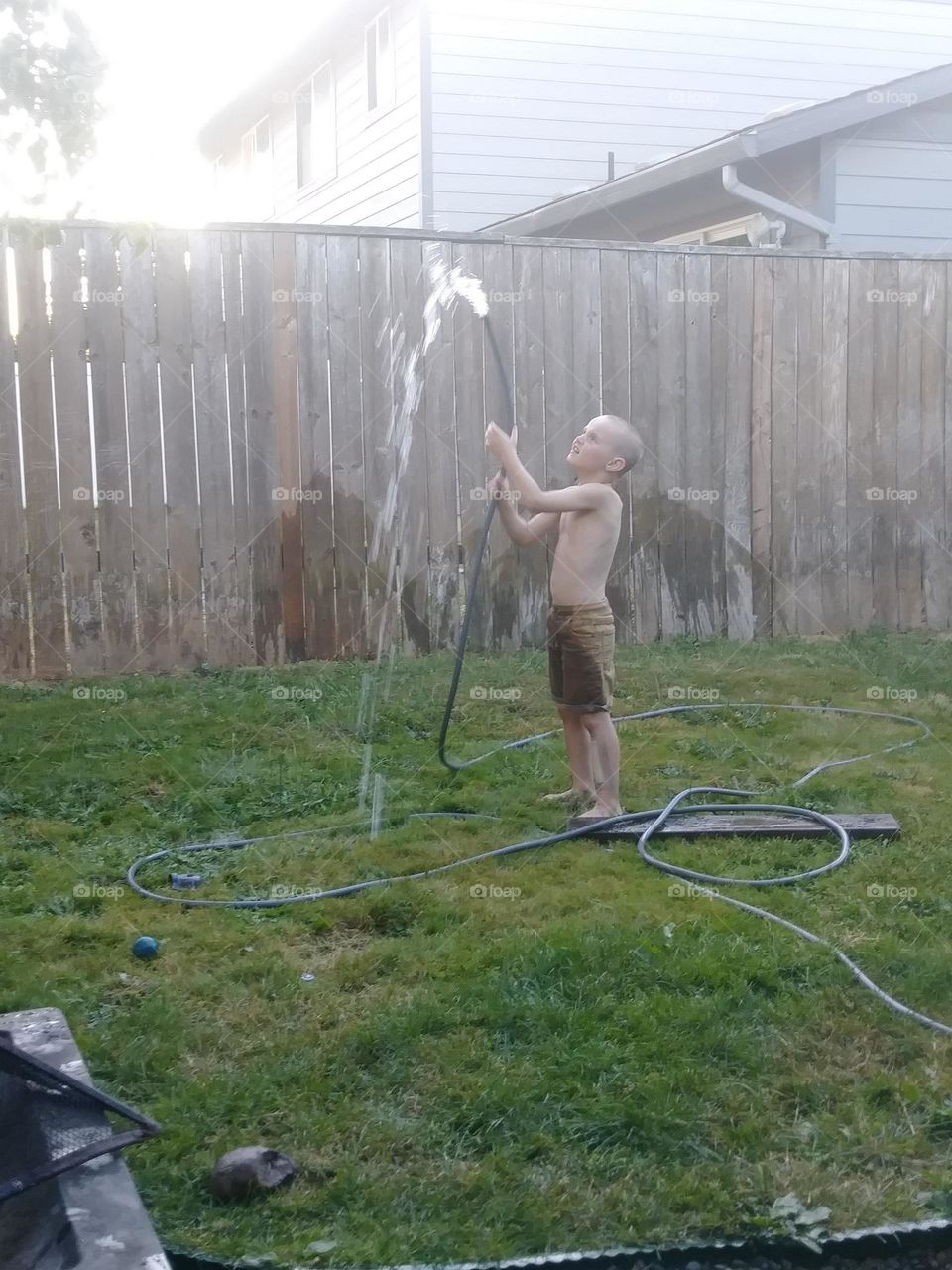 childhood pleasures! water hose drinking fountain. old school fun
