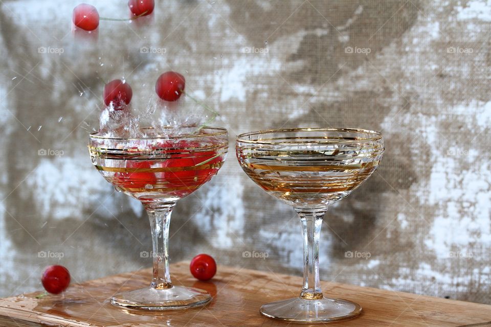 Red cherry in champagne glasses