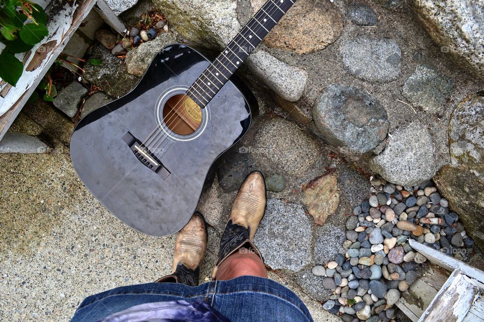 Point of view, cowboy opt clad feet and a few steps with my guitar