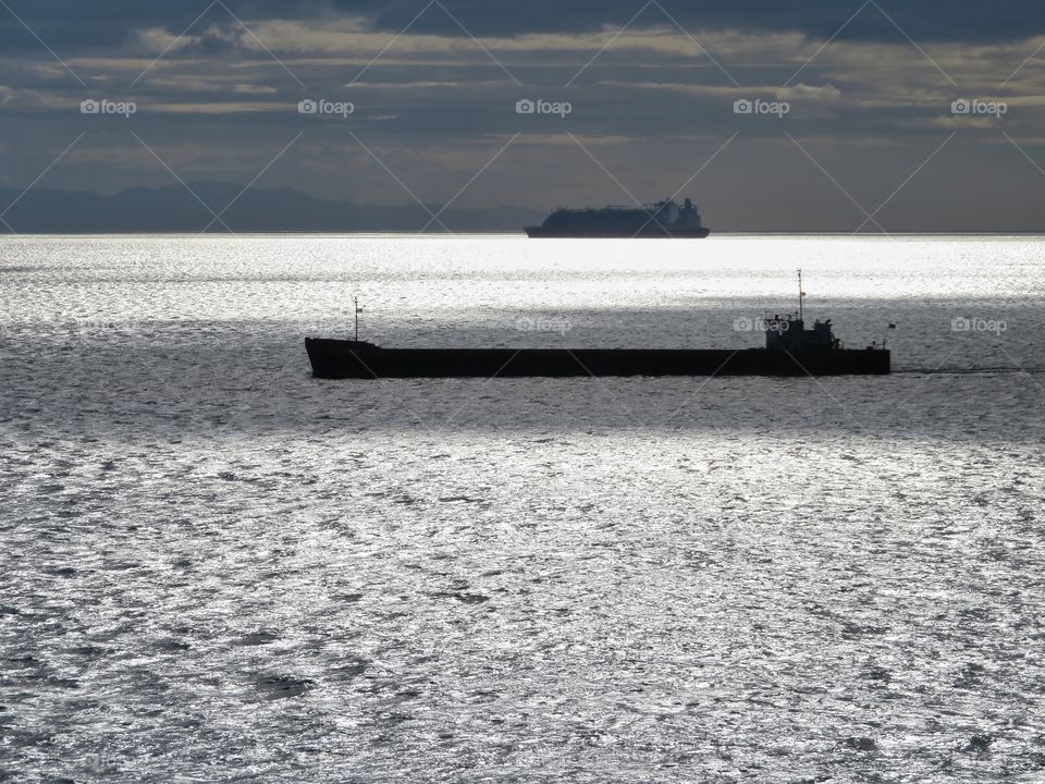 Ships in "Frozen sea". Sun reflection over mediterranean sea, without filter.