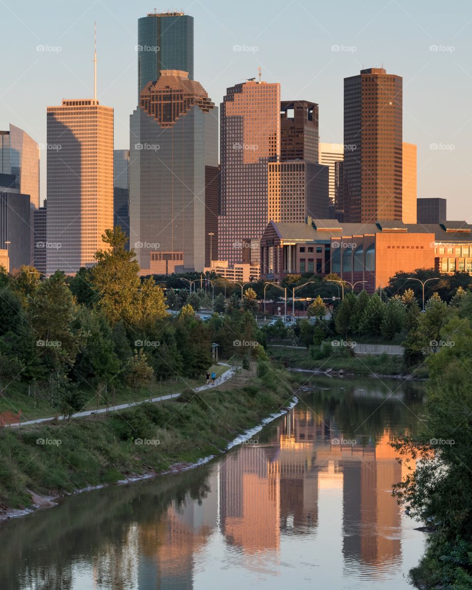 Downtown Houston reflected in Buffalo Bayou by late afternoon sunlight