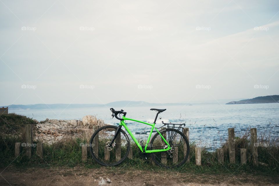 Green Bicycle Standing Near Water