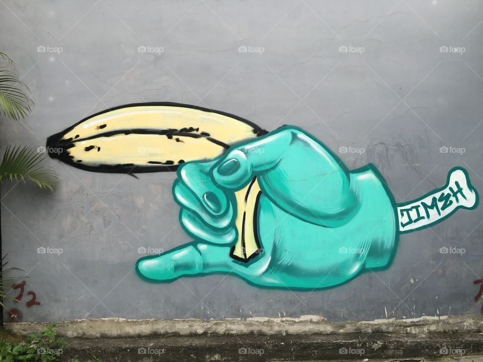Hand Holding a Banana - Graffiti Street Art