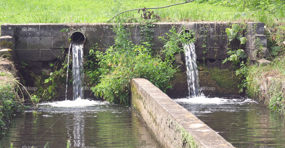 Two Water Pipes At Work Over A Canal
