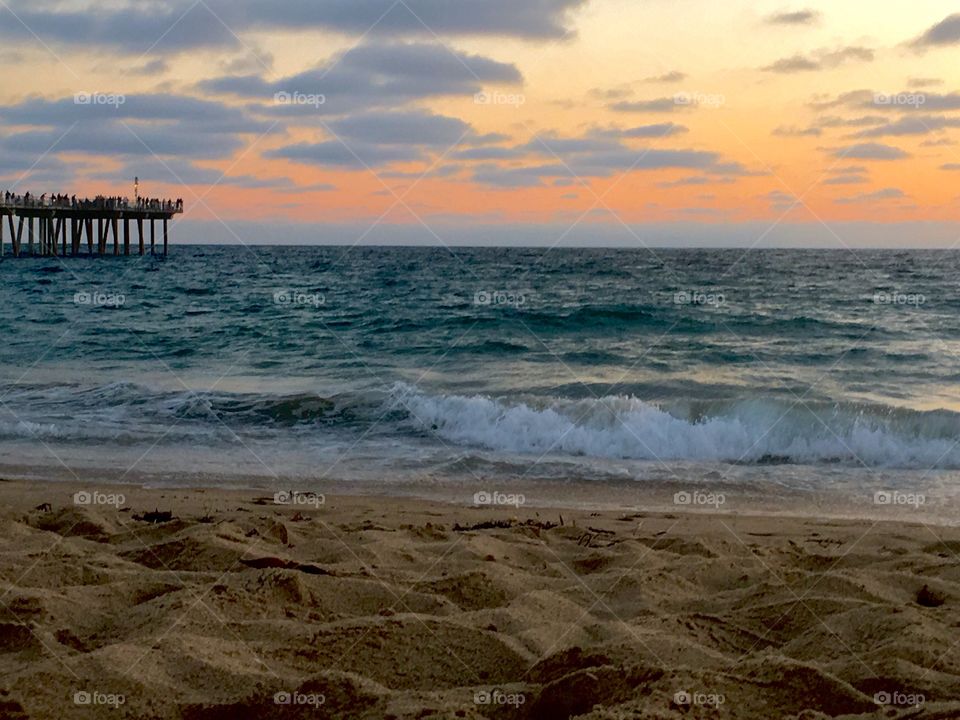 Pier by the beach at sunset