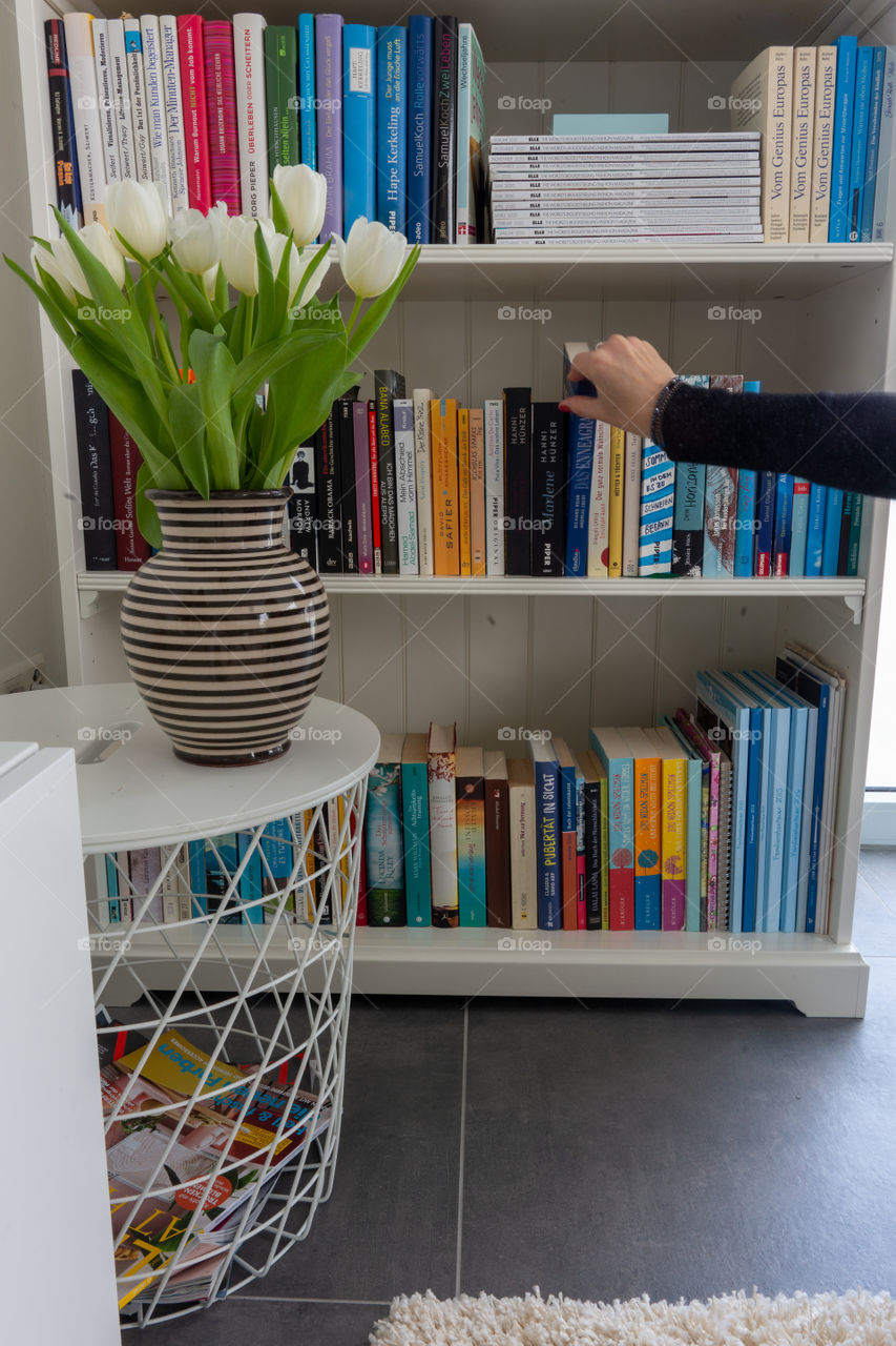 bookshelf and a hand