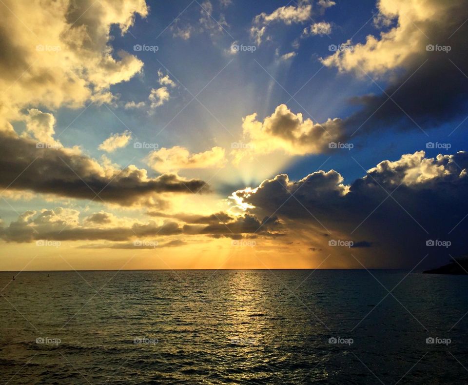 Sunrise over the water, ocean views, sunrise on the beach, views from paradise, through the clouds 