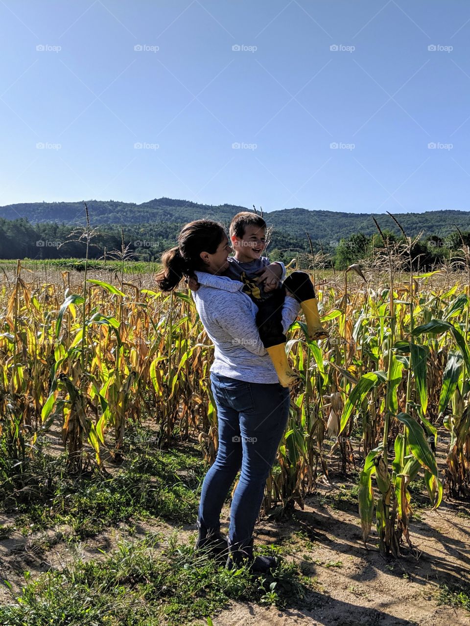 mother and son in corn field