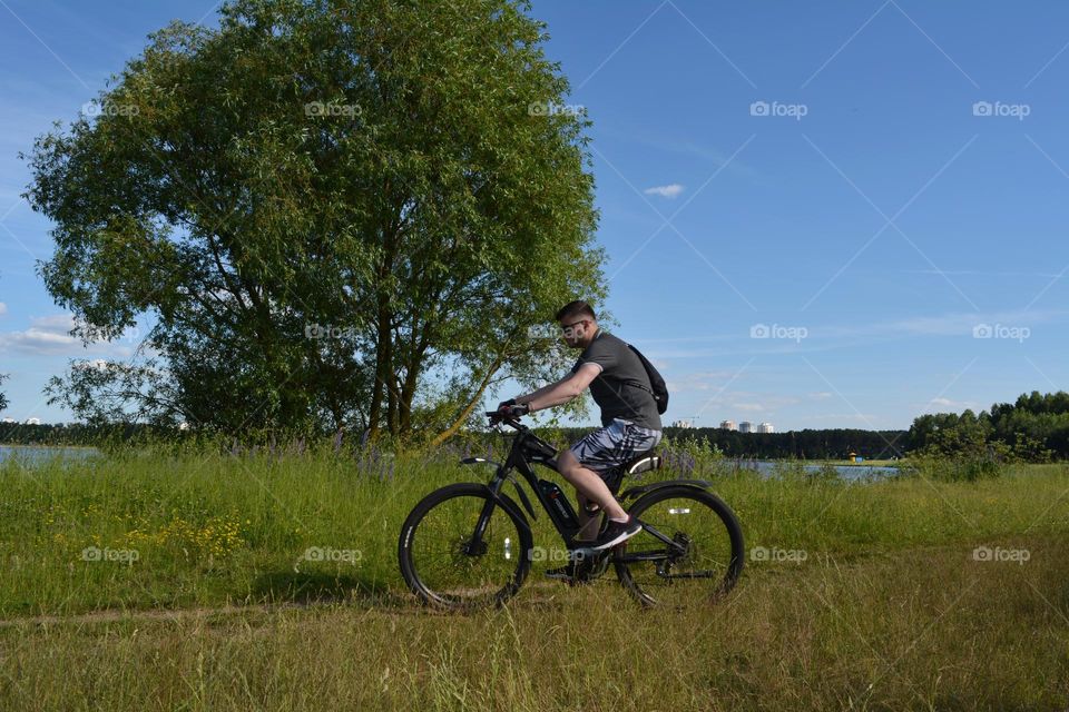 men riding on a bike summer time, beautiful summer nature landscape