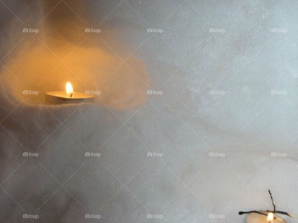 Candle inside a mini snow house 