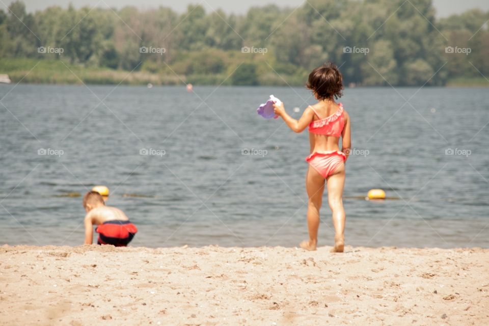 Brother an sister playing on the beach