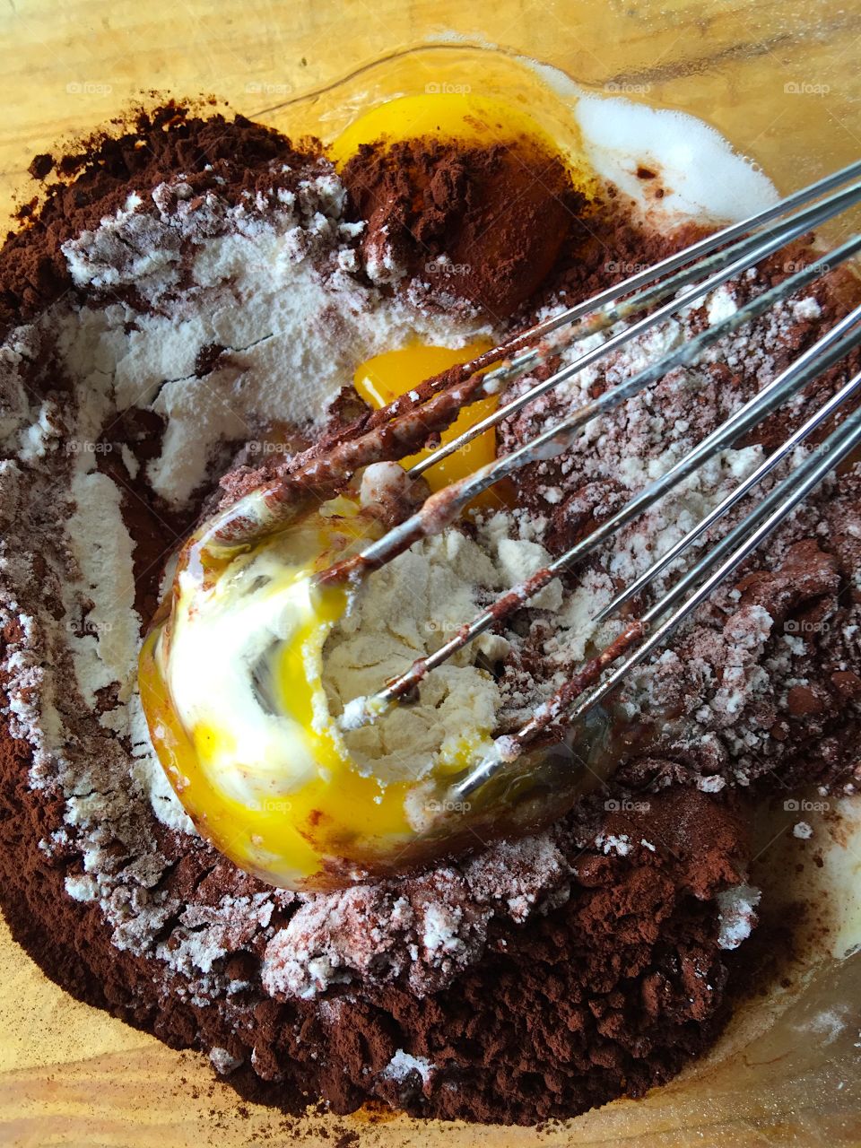 Whisking egg into chocolate cake batter