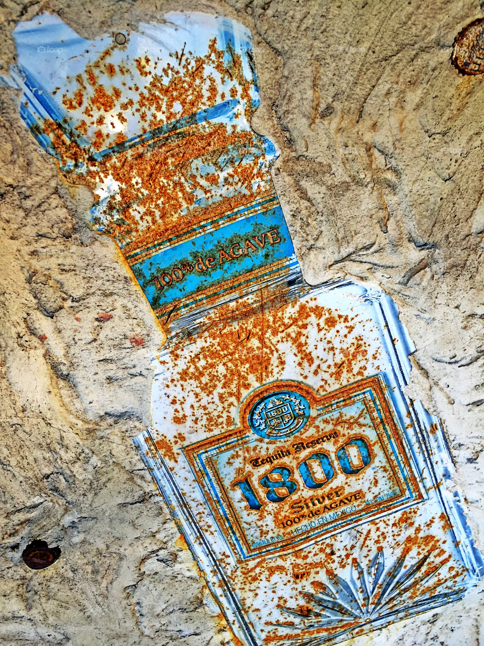 Tequila reserva 1800 rusty advertising at an outdoor tiki bar.