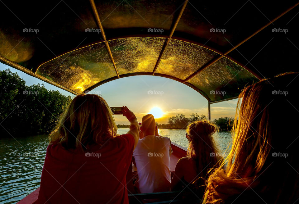 boat trip at mangrove swamp during sunset
