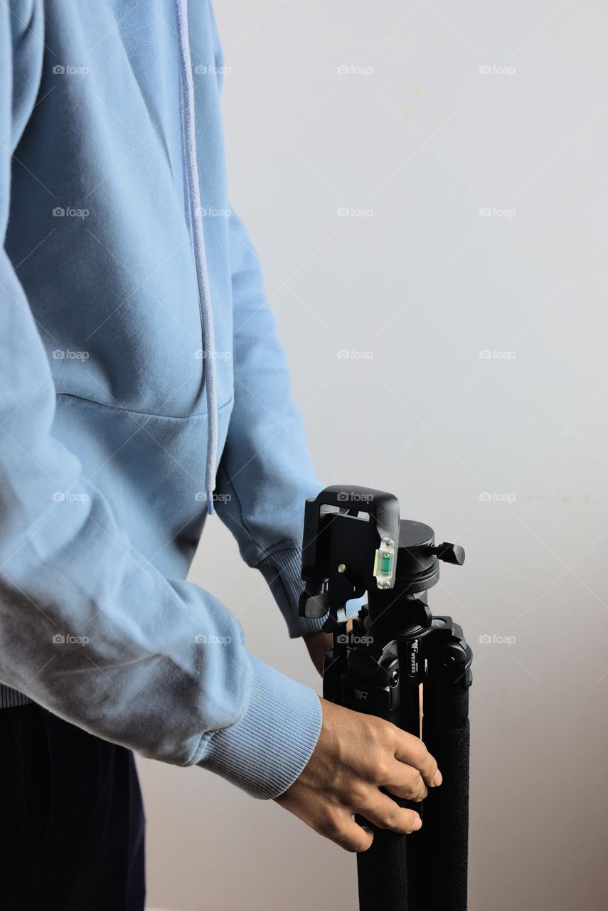 Person with a tripod for video photography