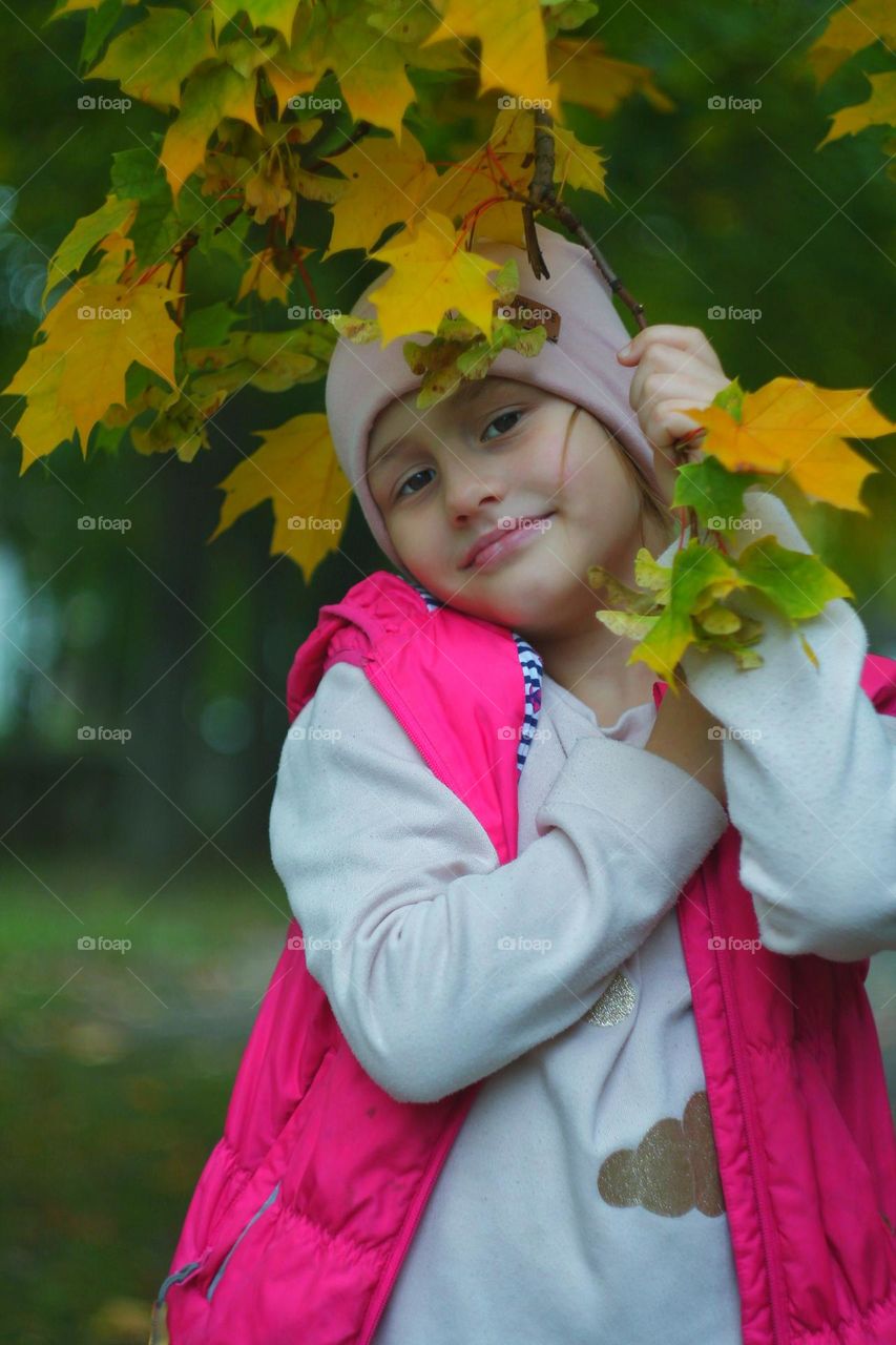 girl and autumn maple leaves