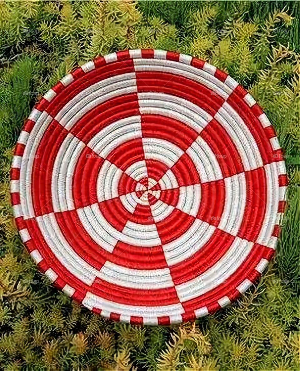 The image shows a group of hand -made dishes of wicker, decorated with colored embroideries with beautiful floral shapes, and is elegantly displayed in a warm corner that combines heritage and beauty, which gives the place an artistic spirit and attr