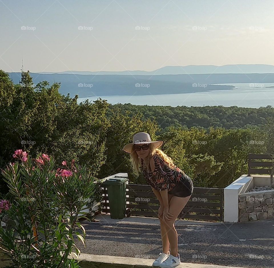 this is me and I am surrounded with wild nature with an image of the sea in the distance