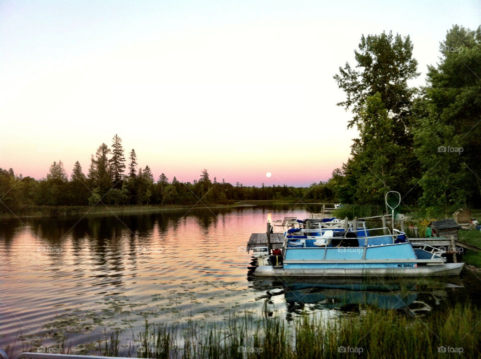 sunset boats trees water by serenitykennedy