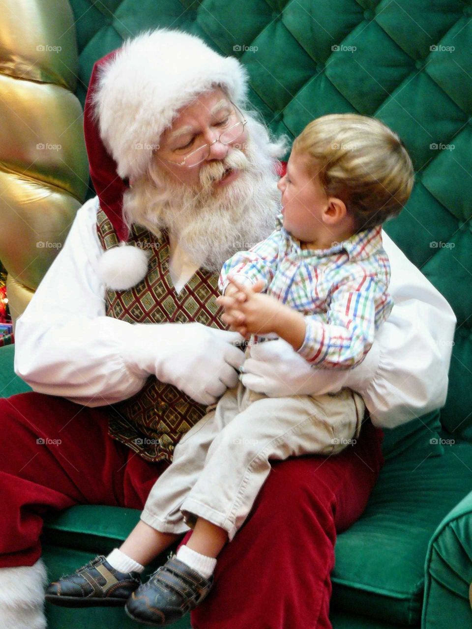 Boy sitting on Santa Claus lap