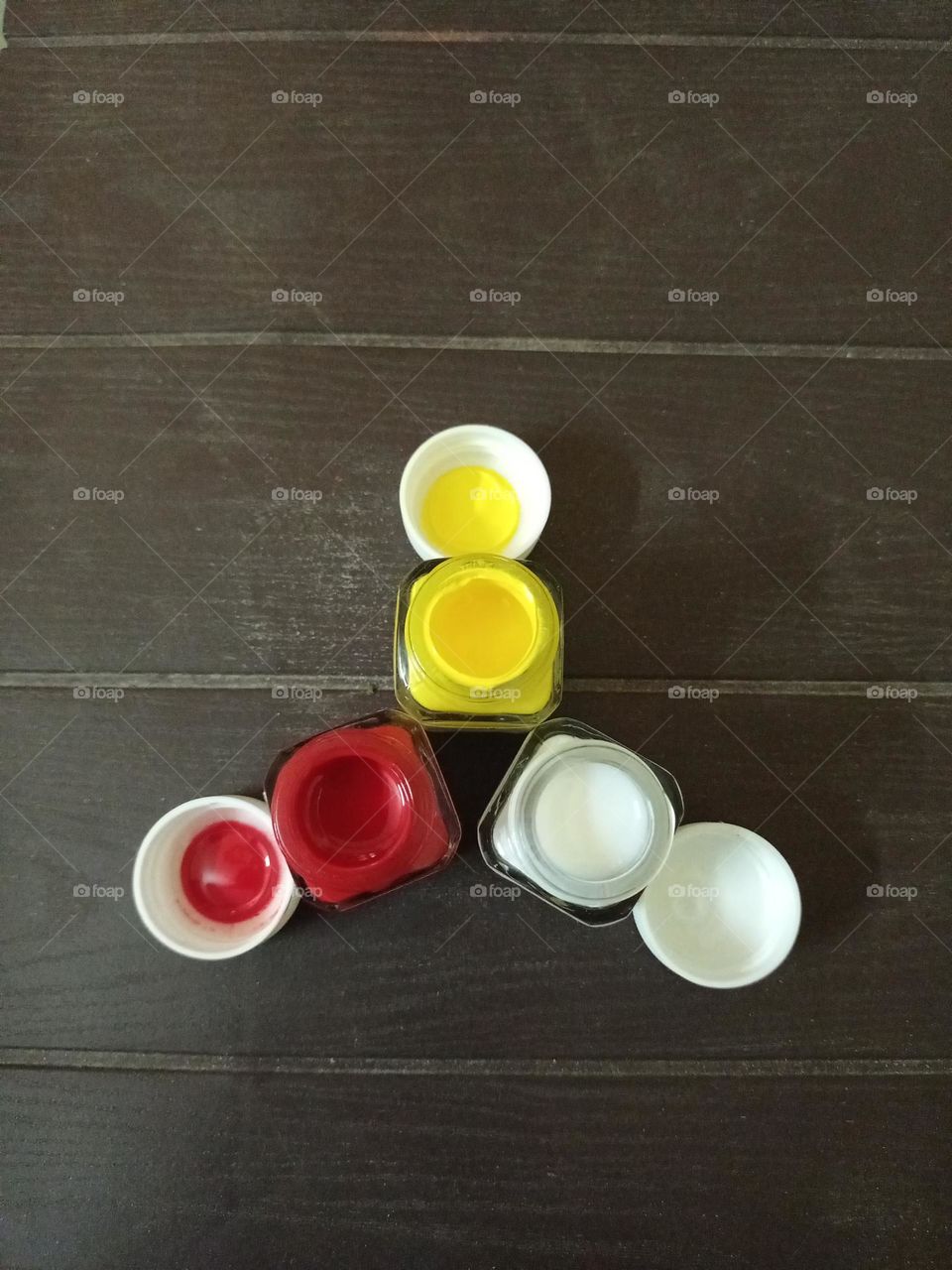 Acrylic paint colour botals in triangle shape closeup photo