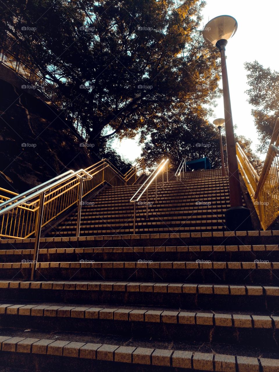 At dusk, the metal handrails on the steps reflect sunlight.