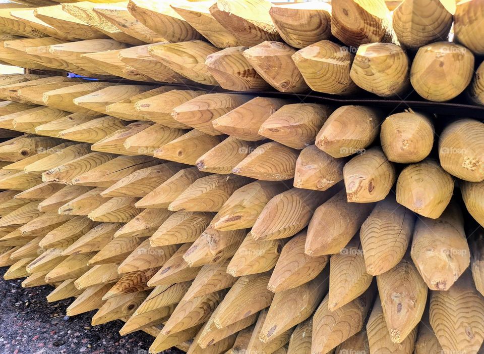 Perspective view to the wooden stacks with sharp triangle shaped ends