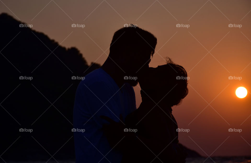 Couple kissing during a sunset