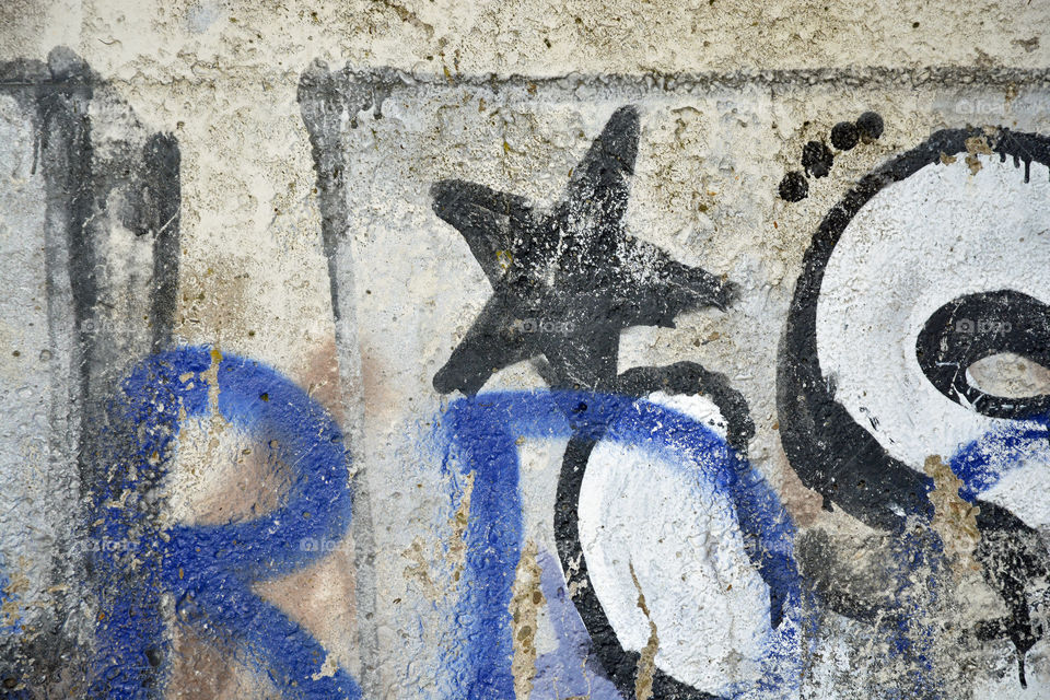 Close up of a grafitti art wall with black blue paint