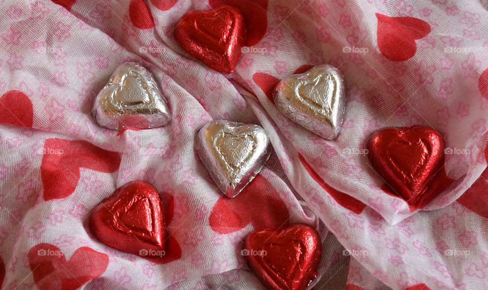 Heart shaped chocolate candy on fabric background