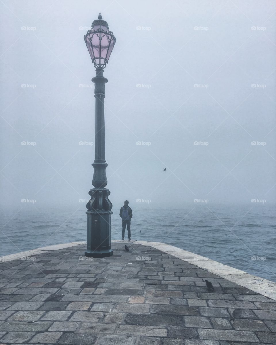 Staring out into the eerie fog in Venice, Italy.