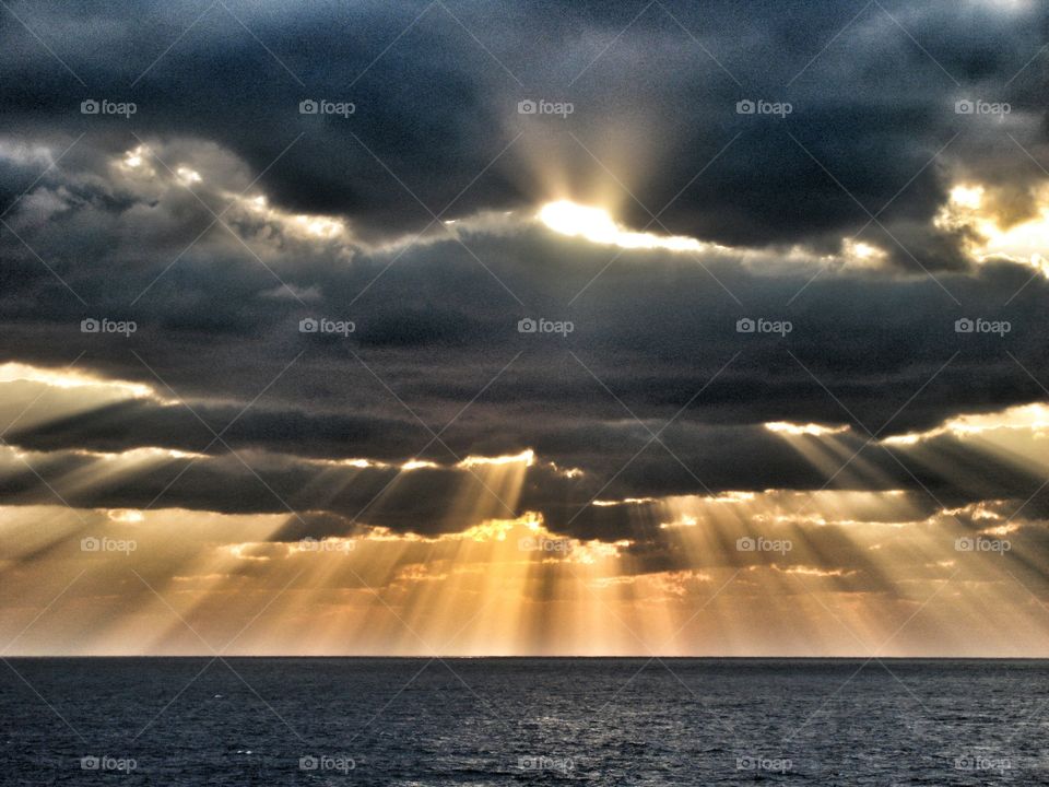 Sunbeams through cloudy sky