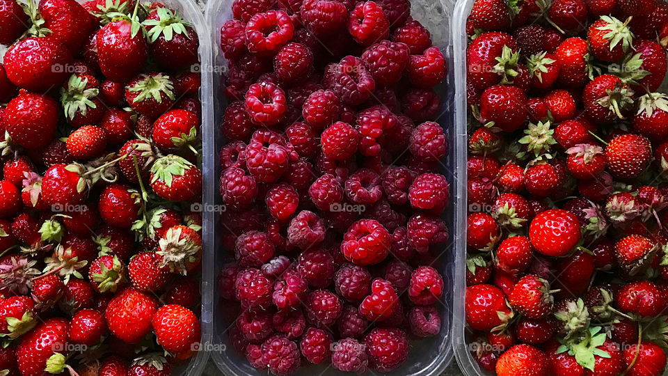 Fresh ripe raspberries and strawberries 