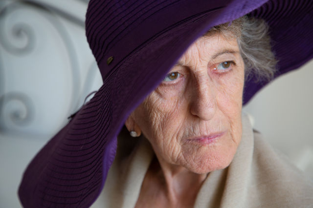 Senior woman in her 70s in the hat with wide brims.