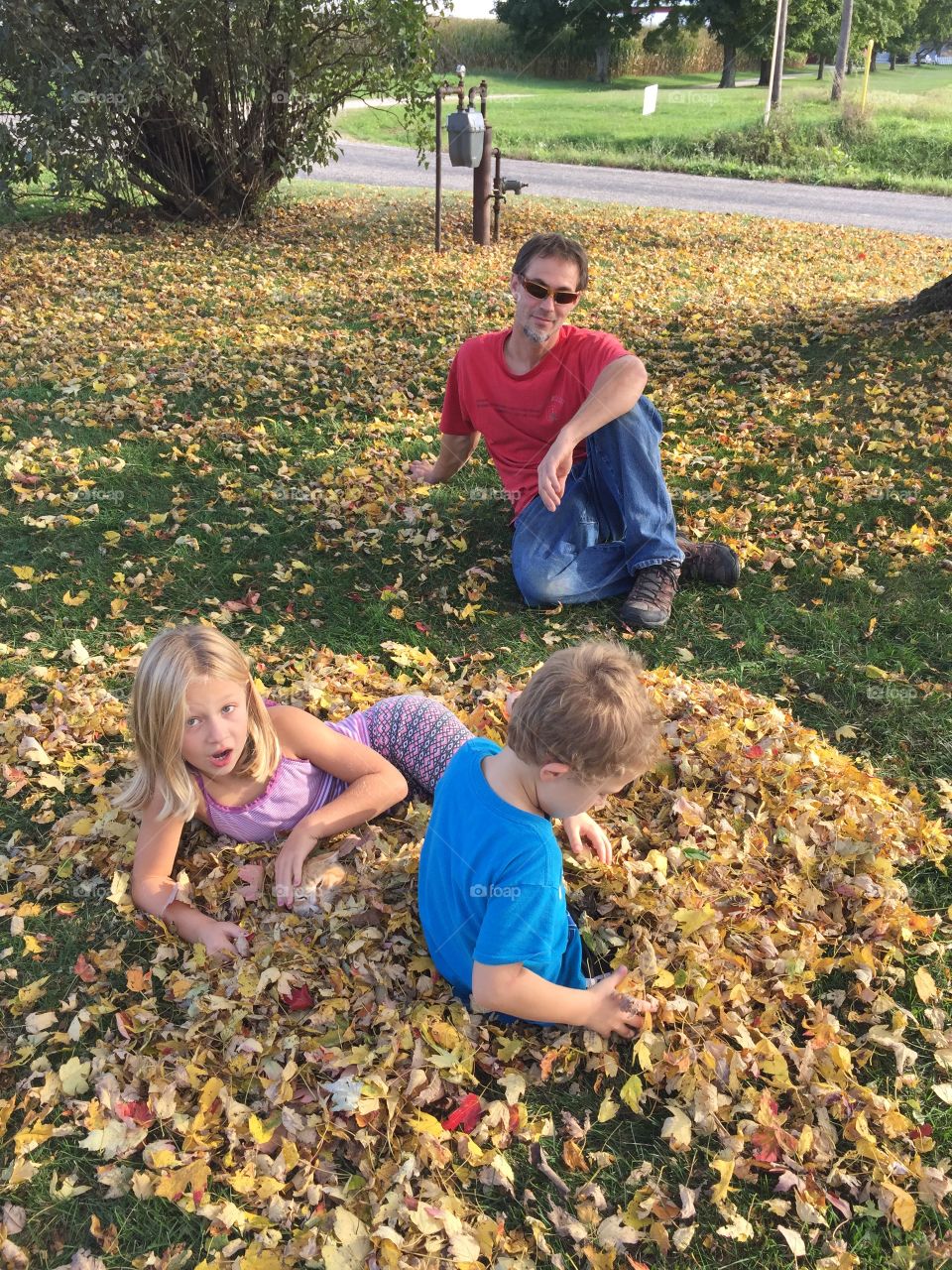 Daddy's pile of leaves. Just playing in the leaves one day after school
