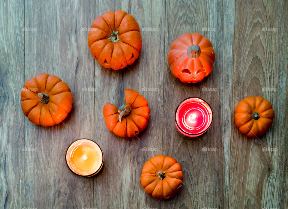 pumpkins and candles on the wooden table