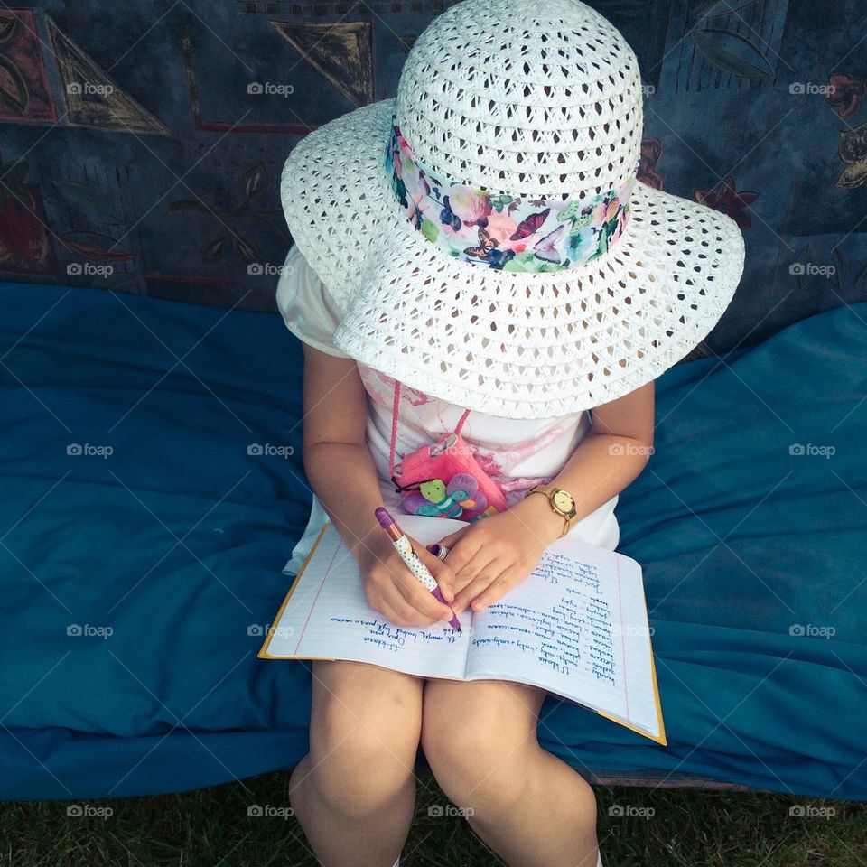 Girl doing her homework in the garden