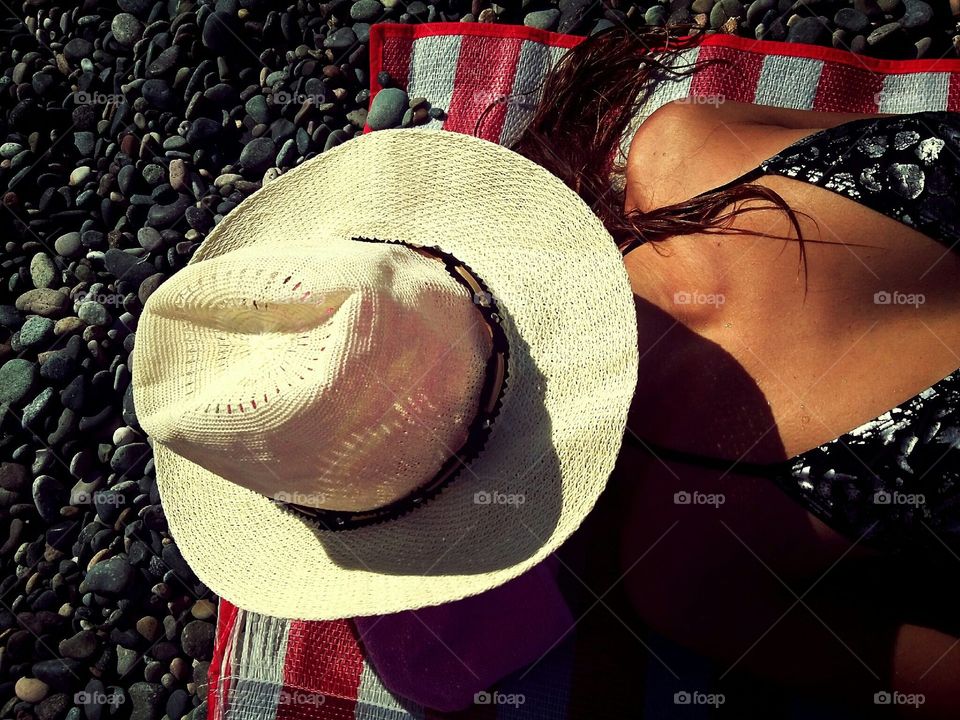 A girl on a beach. It is my friend taking a tan on a beach.