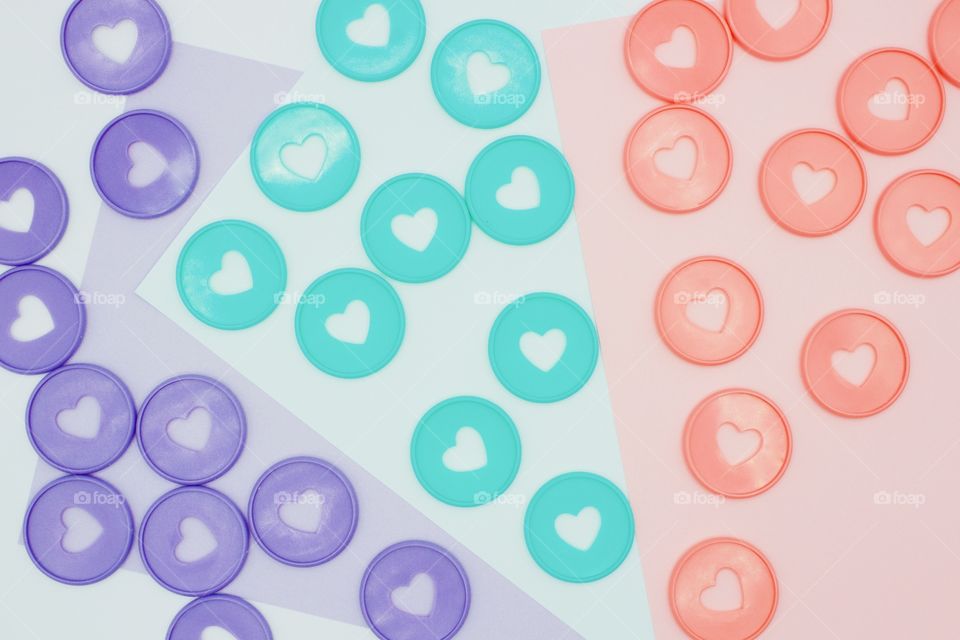 Overhead view of assorted pastel-colored discbound discs with heart-shaped cut-out on matching paper