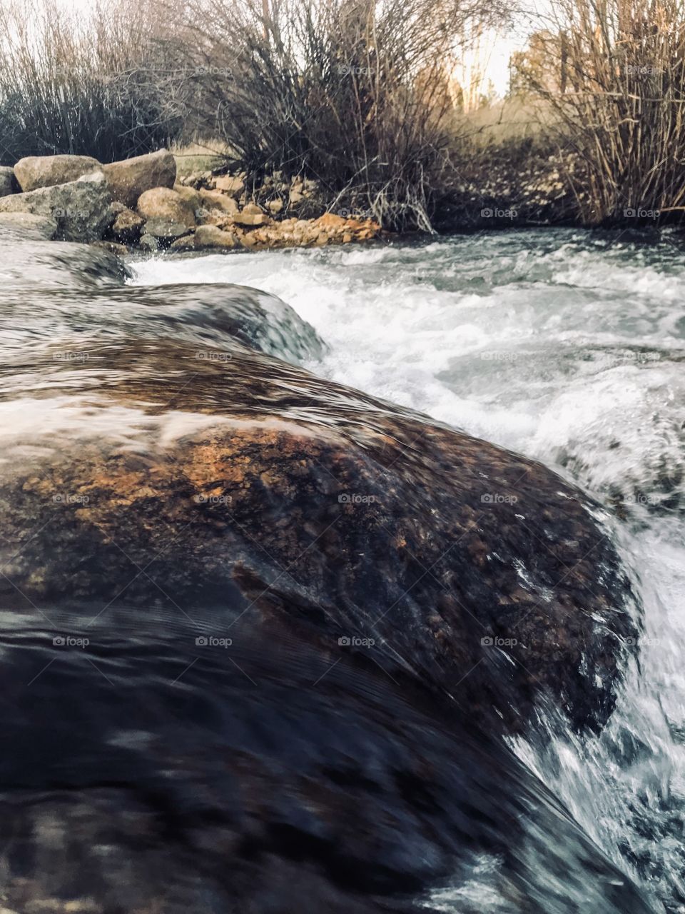 Water flowing softly over the rocks of Pine Creek River in Pinedale, Wyoming 