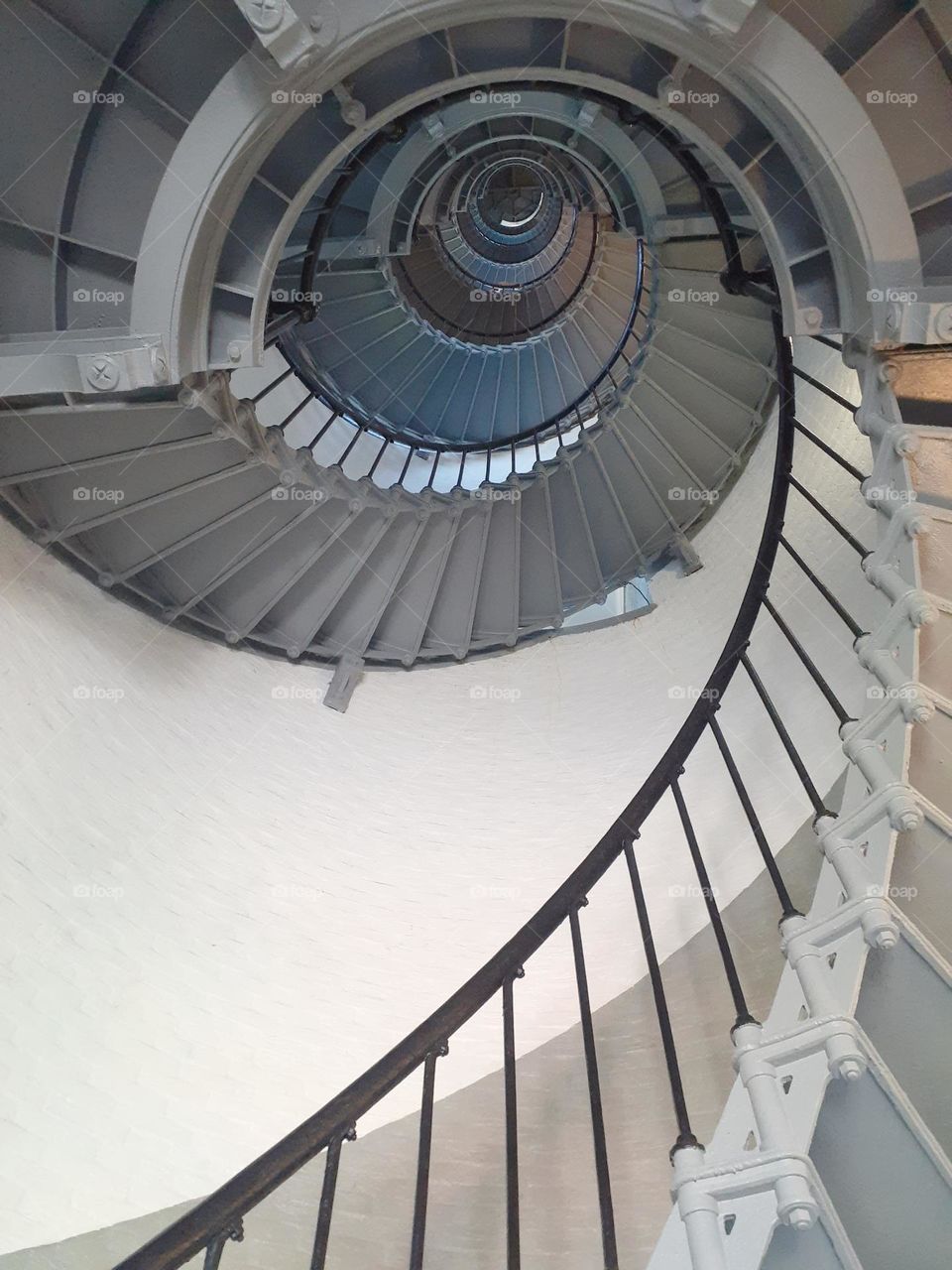 The steep spiral staircase of the Ponce Inlet Lighthouse in Ponce Inlet, Florida taken from below.