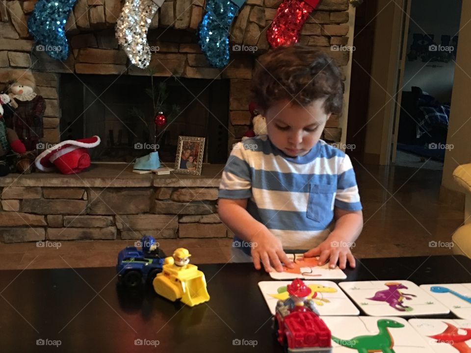 Little boy playing with his toys.