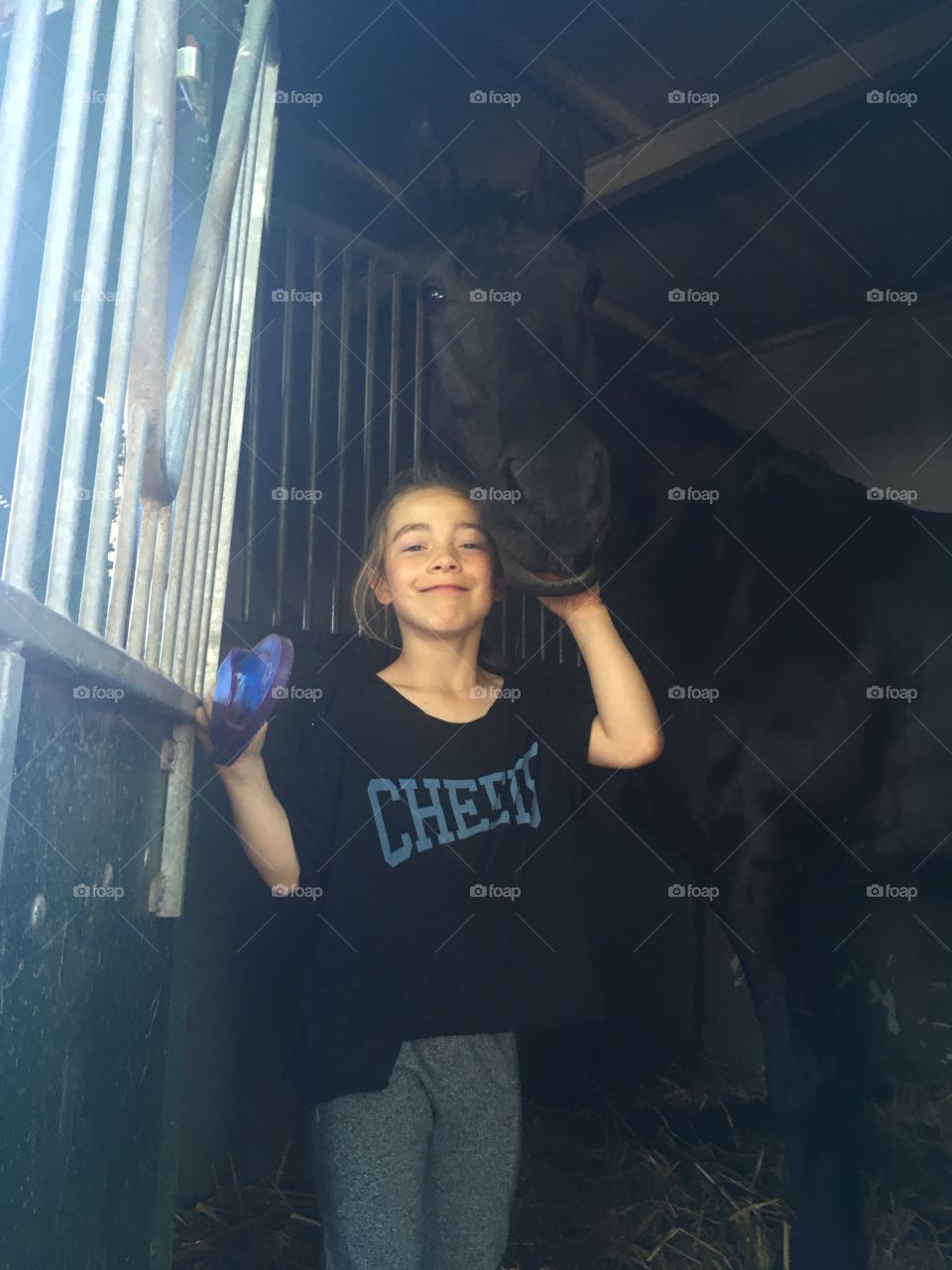 Child with big black horse 