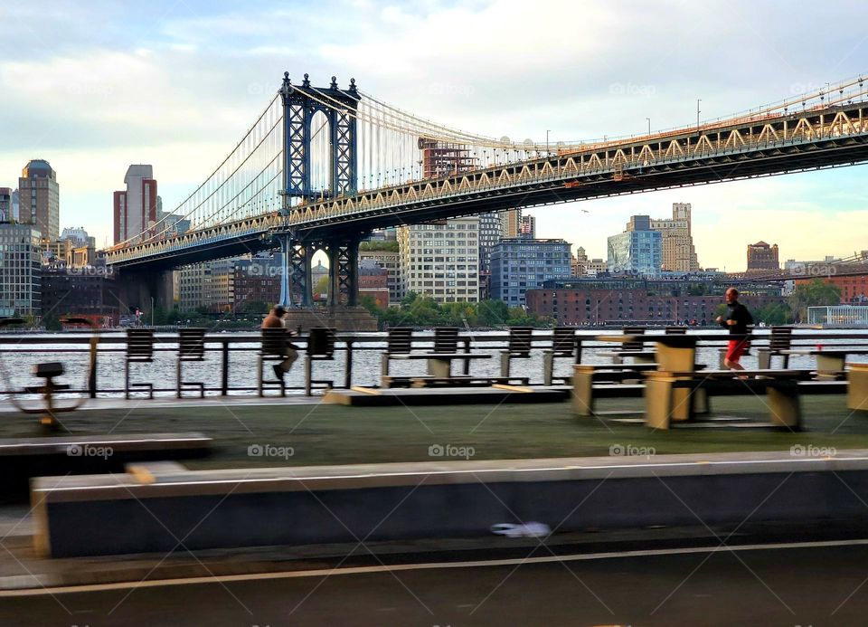 People work out near the Manhattan Bridge