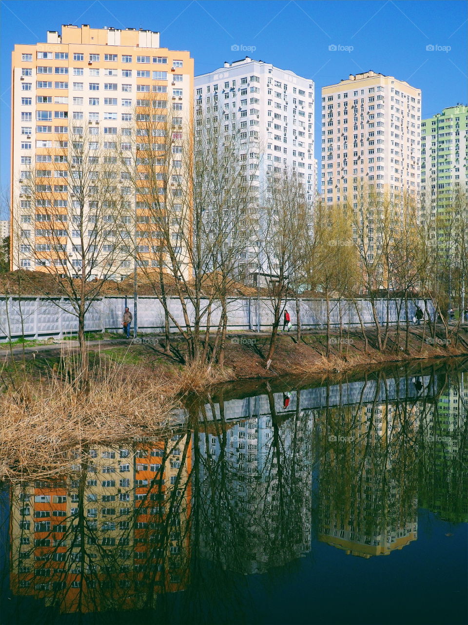 mirror reflection of residential buildings in the lake