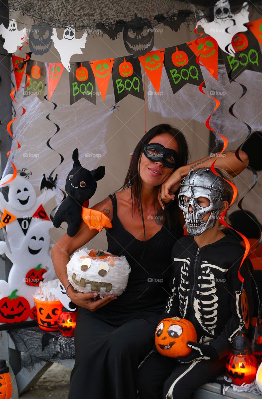 Mom and son at the Halloween decorations, beautiful  family 