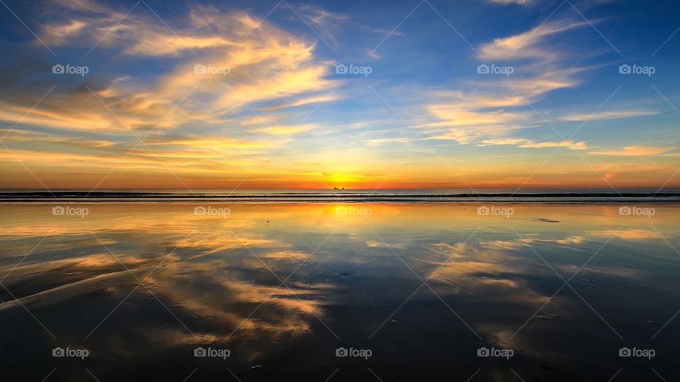 Sunset and cloud reflection over the ocean