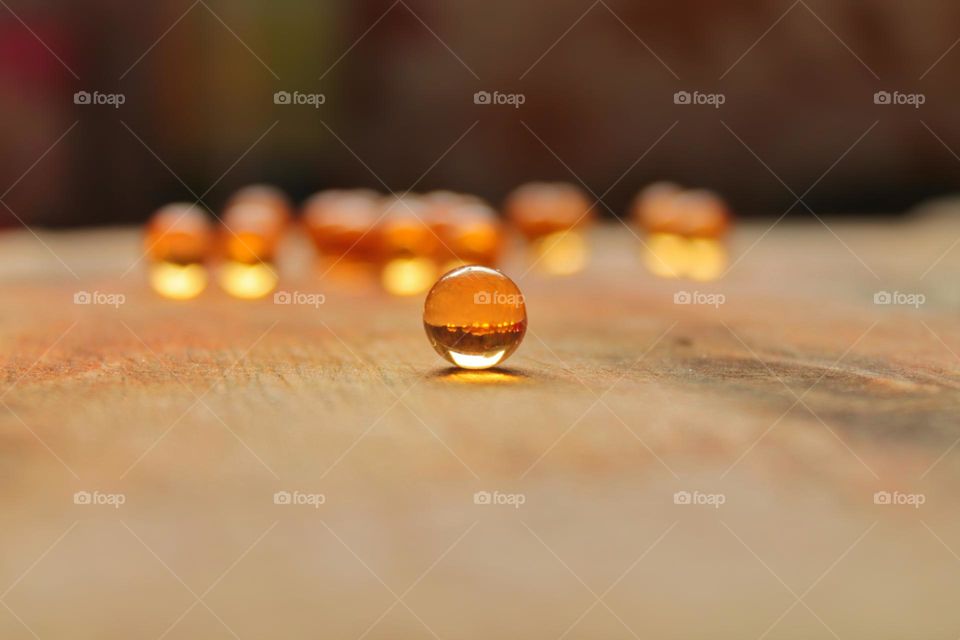 small round fish oil tablets on a board