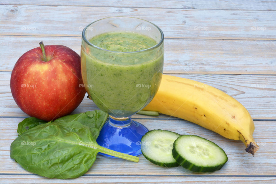 Green smoothie in a glass with apple cucumber